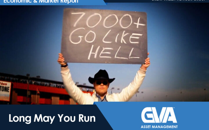 Person in a hat and sunglasses holds up a sign reading '7000+ GO LIKE HELL' at a stadium, with 'Economic & Market Report' branding visible above.